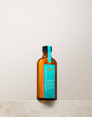 Moroccanoil bottle on a light gray background