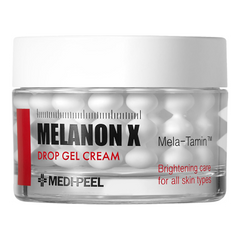 A clear cosmetic jar of MEDI-PEEL Melanon X Drop Gel Cream with a white lid, showing white drop-shaped gel capsules inside, on a plain white background.