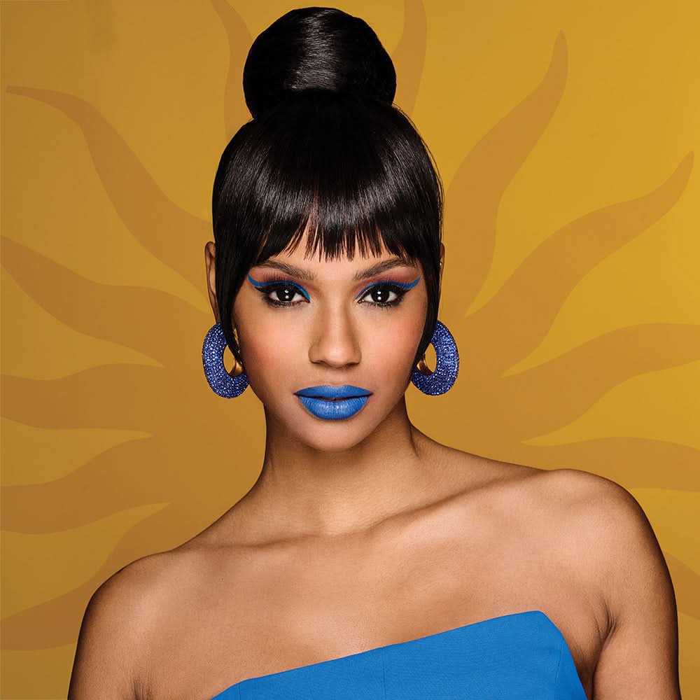 Woman wearing Sleek Style Bun & Bangs Wig in Chocolate Truffle - View from the front